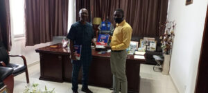 Two men holding textbook