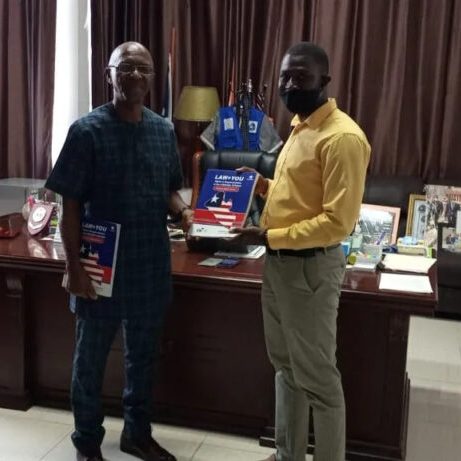 Two men holding textbook